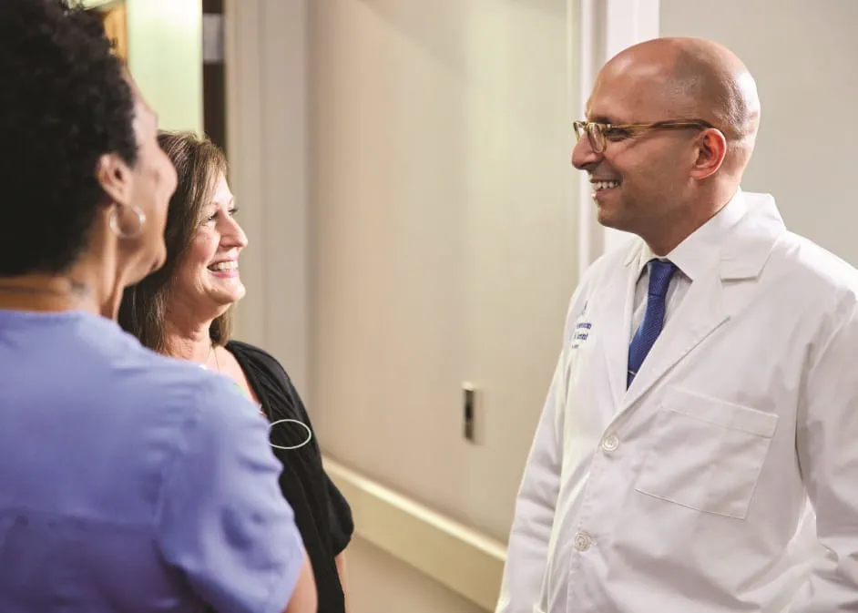 Ascension St. Vincent physician speaking to two care providers